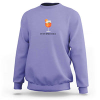 Violet crewneck sweatshirt with small orange drink graphic and “IN MY SPRITZ ERA” text