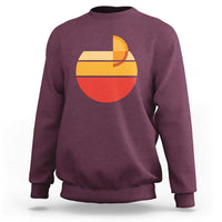 Maroon Aperol Spritz sweatshirt with large retro sunset cocktail graphic on chest