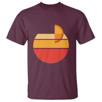 Maroon crew-neck T-shirt with retro sunset graphic in orange, yellow, and red.