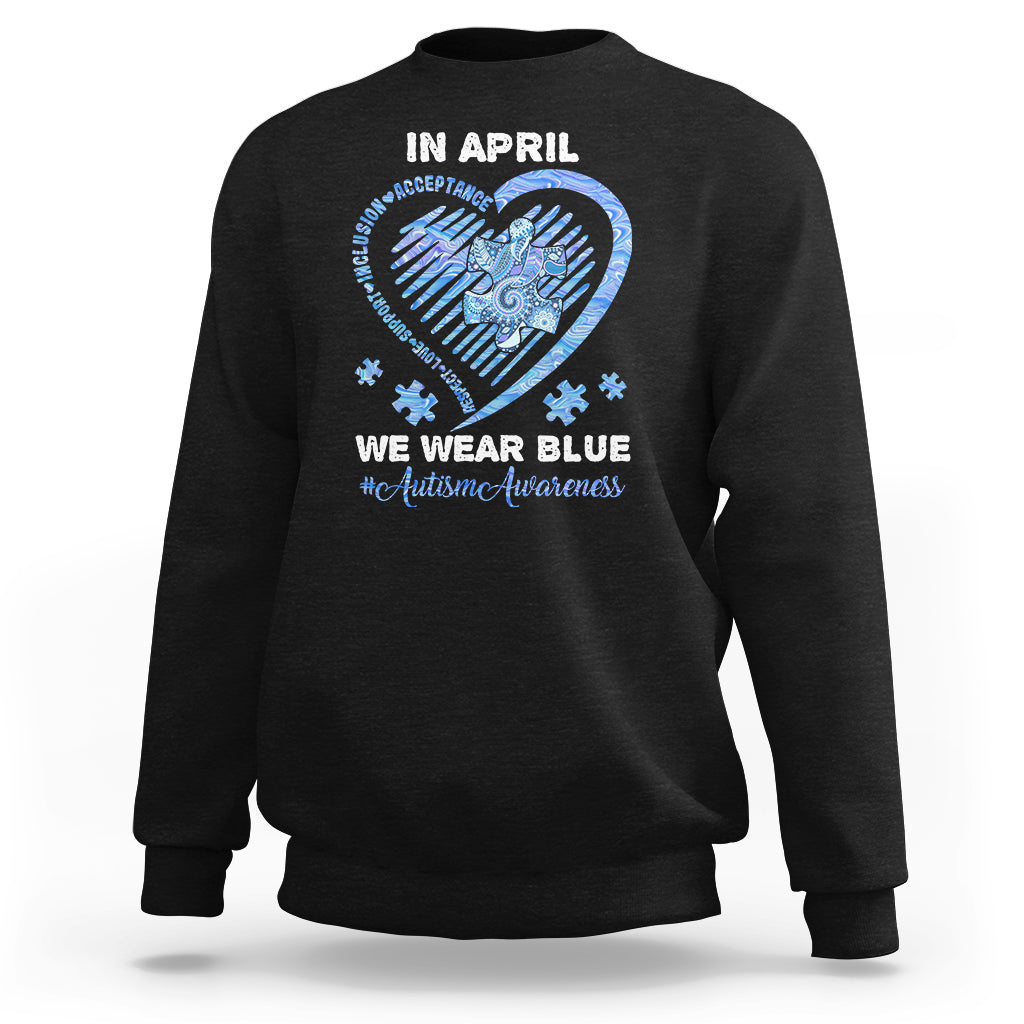 Black crewneck sweatshirt with 'In April' heart graphic and slogan on back.