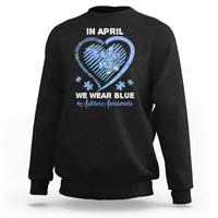 Black crewneck sweatshirt with 'In April' heart graphic and slogan on back.