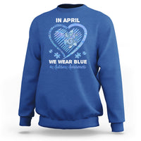 Royal blue crewneck sweatshirt with 'In April' heart graphic and slogan on back.