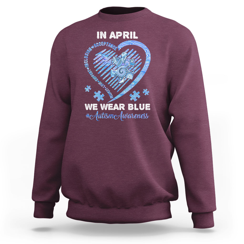 Maroon crewneck sweatshirt with 'In April' heart graphic and slogan on back.