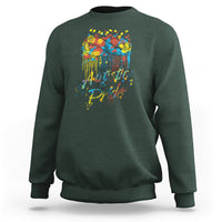 Forest green sweatshirt with colorful "Autistic Pride" graphic and glasses on back