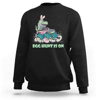 Kids' crewneck sweatshirt in black with Easter dinosaur-bunny graphic, 'EGG HUNT IS ON'.