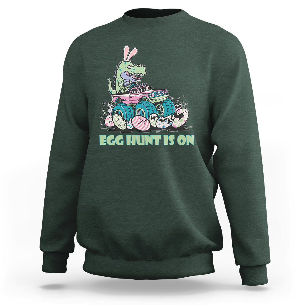 Kids' crewneck sweatshirt in forest green with Easter dinosaur-bunny graphic, 'EGG HUNT IS ON'.