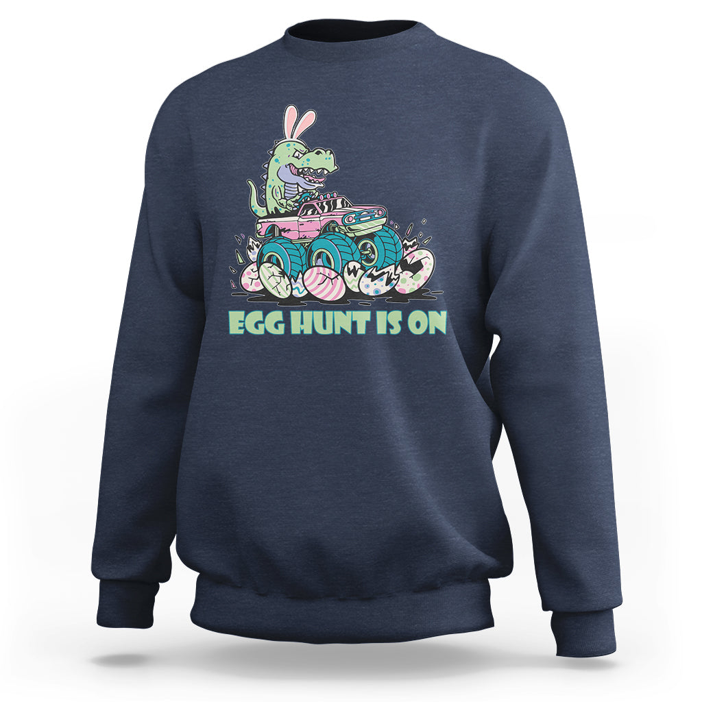 Kids' crewneck sweatshirt in navy blue with Easter dinosaur-bunny graphic, 'EGG HUNT IS ON'.
