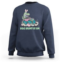 Kids' crewneck sweatshirt in navy blue with Easter dinosaur-bunny graphic, 'EGG HUNT IS ON'.