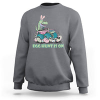 Kids' crewneck sweatshirt in dark gray with Easter dinosaur-bunny graphic, 'EGG HUNT IS ON'.