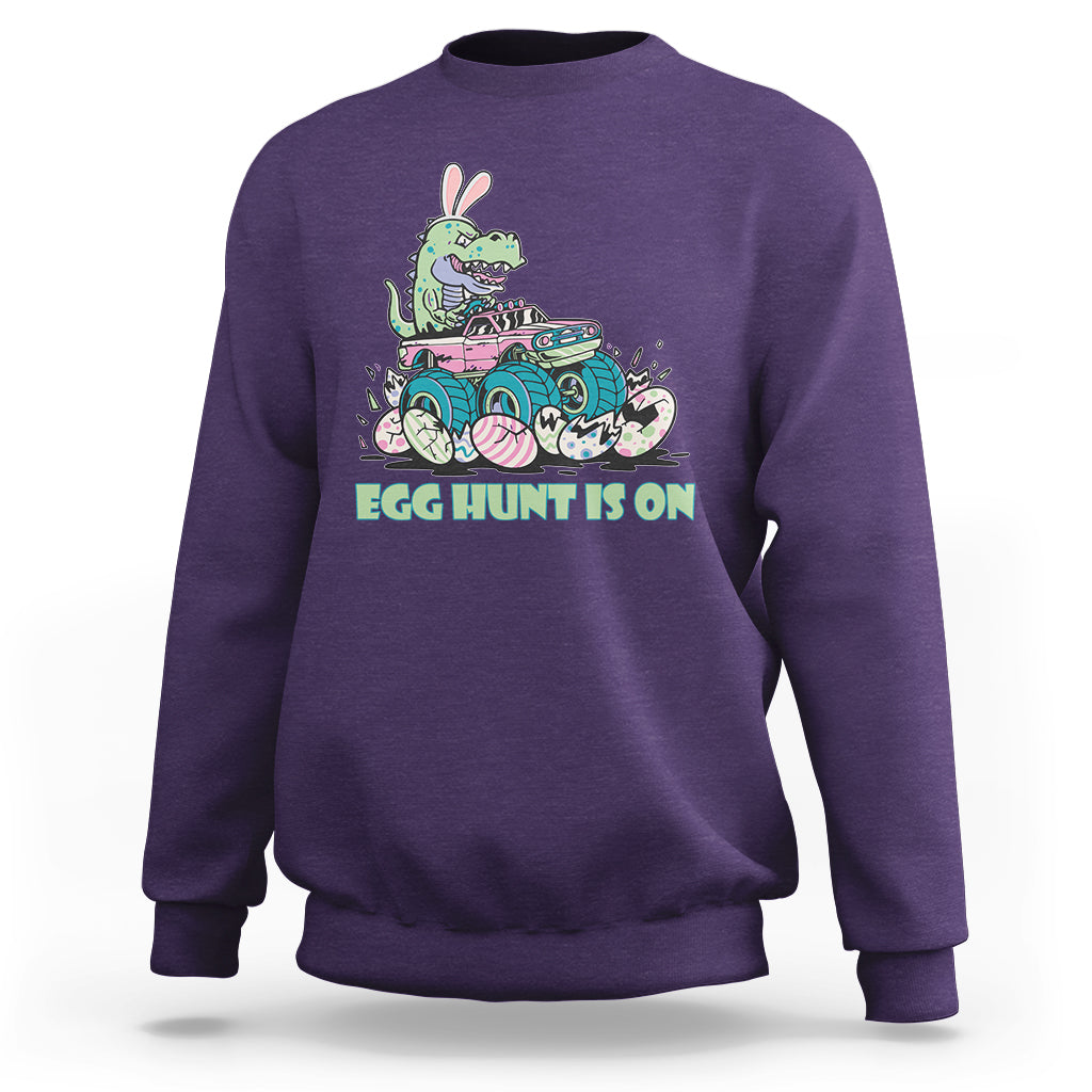 Kids' crewneck sweatshirt in purple with Easter dinosaur-bunny graphic, 'EGG HUNT IS ON'.