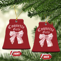 Set of red bell-shaped Christmas ornaments with pink bows and gold hanging strings