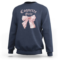 Navy crewneck sweatshirt with pink bow graphic on chest, ribbed cuffs and hem.