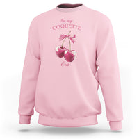 Light pink sweatshirt with bow and cherry graphic, crewneck and long sleeves.