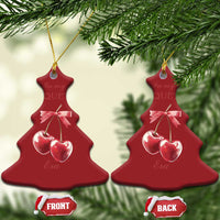 Red Christmas tree-shaped ornament with pink ribbon bow and two cherry charms on gold hook