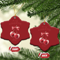 Two red star-shaped ornaments with pink ribbon bow and two cherry charms on gold hooks