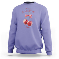 Violet sweatshirt with cherry and bow graphic at chest, crew neck