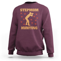 Maroon crewneck sweatshirt with “STEPMOM HUNTING” graphic and dog silhouette with hearts