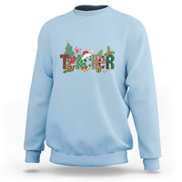 Light blue Christmas sweatshirt with colorful “Merry Xmas” graphic and crew neck