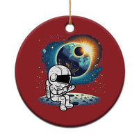 Red round astronaut space ornament with cartoon astronaut holding a globe planet