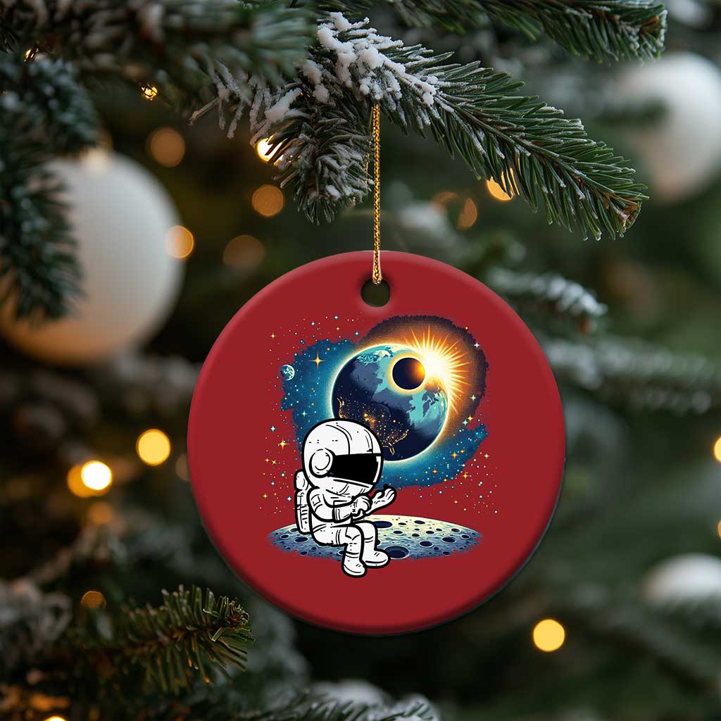 Red round astronaut space ornament with cartoon astronaut and glowing planet