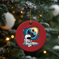 Red round astronaut space ornament with cartoon astronaut and glowing planet