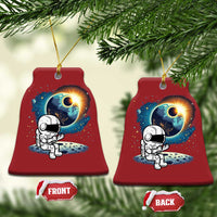 Two red bell-shaped astronaut space ornaments with cartoon astronaut and planet glow