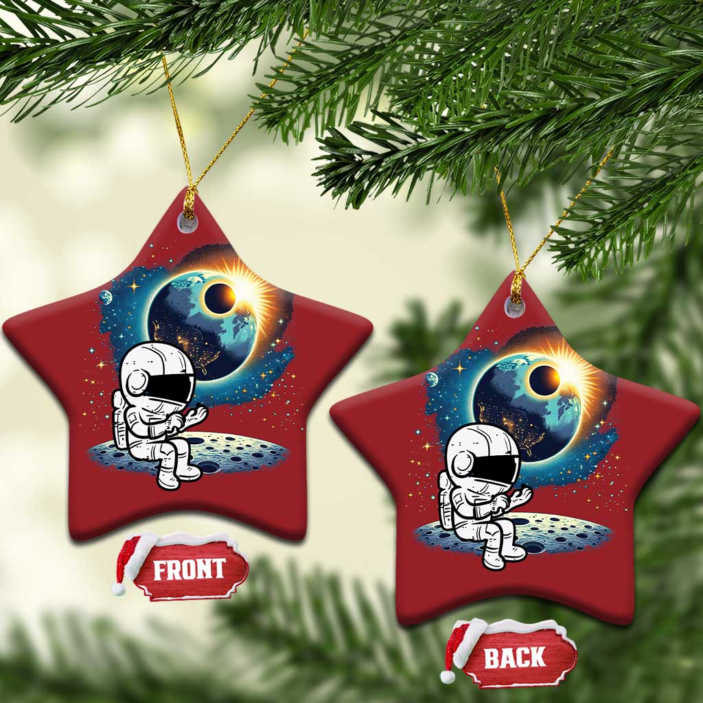 Two red star-shaped astronaut space ornaments with cartoon astronaut and planet glow