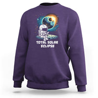 Purple crewneck sweatshirt with astronaut eclipse front graphic