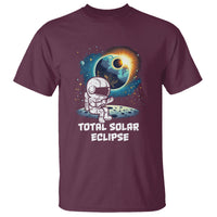 Maroon astronaut graphic T-shirt with eclipse sun and “TOTAL SOLAR ECLIPSE” print