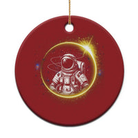 Red round astronaut Christmas ornament with glowing space scene and hanging gold string