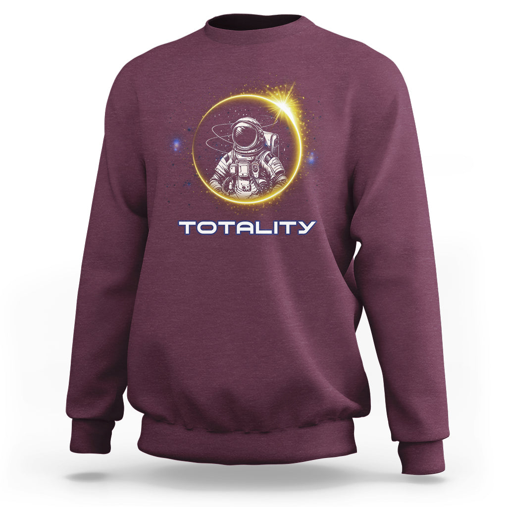 Maroon sweatshirt with astronaut graphic and “TOTALITY” text on the front