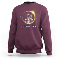 Maroon sweatshirt with astronaut graphic and “TOTALITY” text on the front