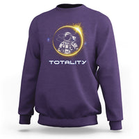 Purple sweatshirt with astronaut graphic and “TOTALITY” text on the front