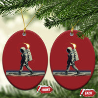 Two red round astronaut ornaments with gold hangers and printed space walking scene