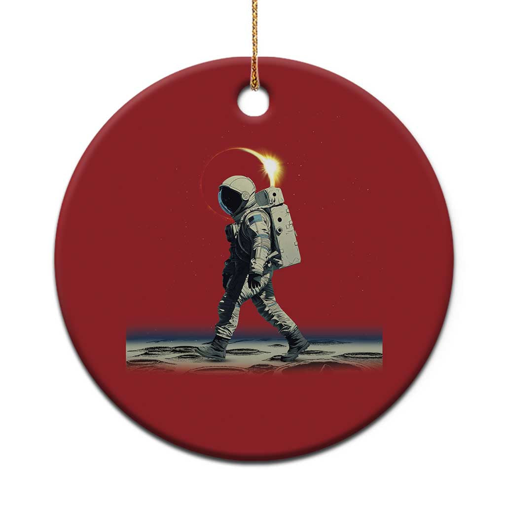 Red round astronaut walking ornament with gold hanging cord and printed space scene