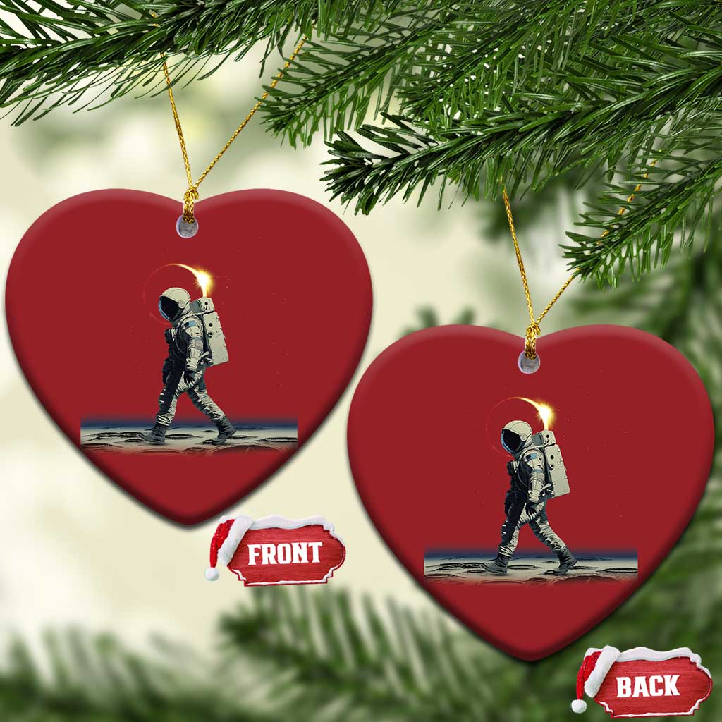 Pair of red heart-shaped astronaut ornaments with gold hangers and a space walking scene