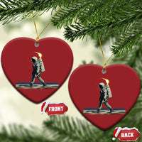 Pair of red heart-shaped astronaut ornaments with gold hangers and a space walking scene