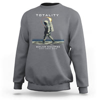 Gray crewneck sweatshirt with astronaut eclipse graphic and “TOTALITY” text on back