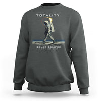 Dark gray crewneck sweatshirt with astronaut eclipse graphic and “TOTALITY” text on back