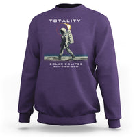 Purple crewneck sweatshirt with astronaut eclipse graphic and “TOTALITY” text on back