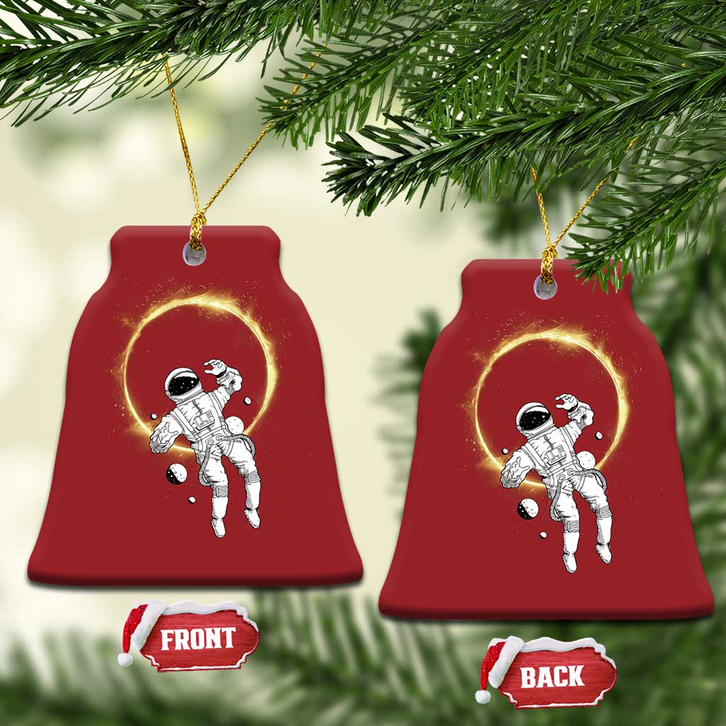 Set of two red bell-shaped astronaut ornaments with glowing halo rings; front/back shown