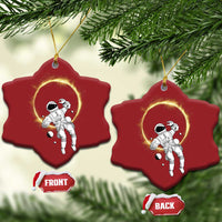 Set of two red star-shaped astronaut ornaments with glowing halo rings; front/back shown