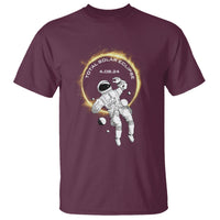 Maroon astronaut solar eclipse T-shirt with circular mission graphic on front