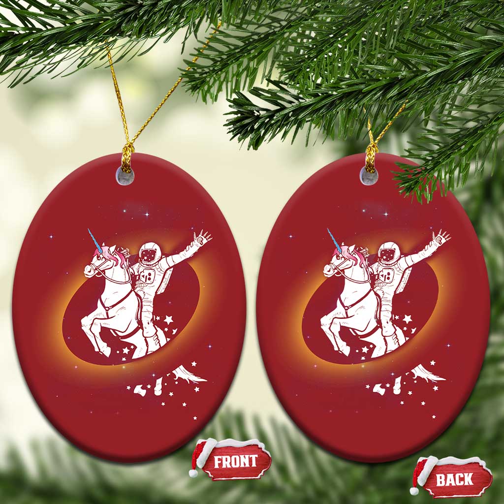 Pair of red oval Christmas ornaments with astronaut riding unicorn galaxy design