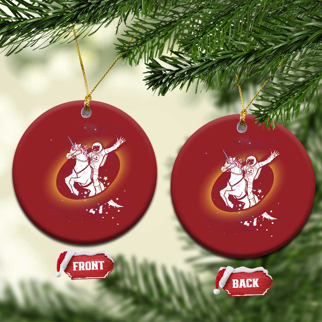 Pair of red round Christmas ornaments with astronaut riding unicorn galaxy design