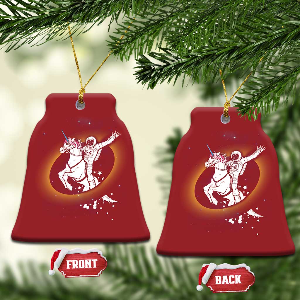Set of red bell-shaped Christmas ornaments with astronaut riding unicorn galaxy art