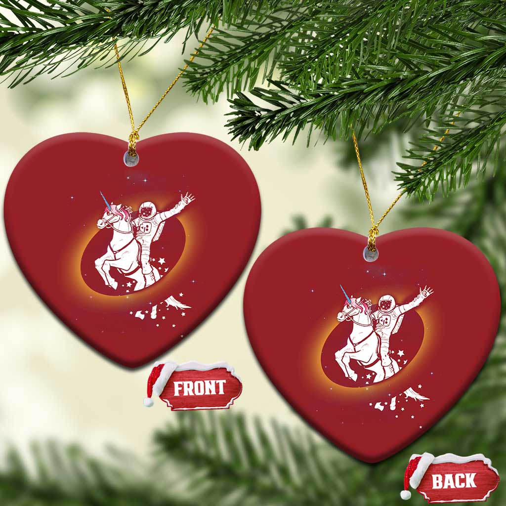Set of red heart-shaped Christmas ornaments with astronaut riding unicorn artwork