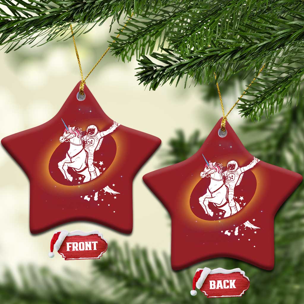 Red star-shaped Christmas ornaments featuring astronaut riding unicorn in a glow circle