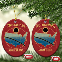 Two red oval solar eclipse map Christmas ornaments with gold hanging loops