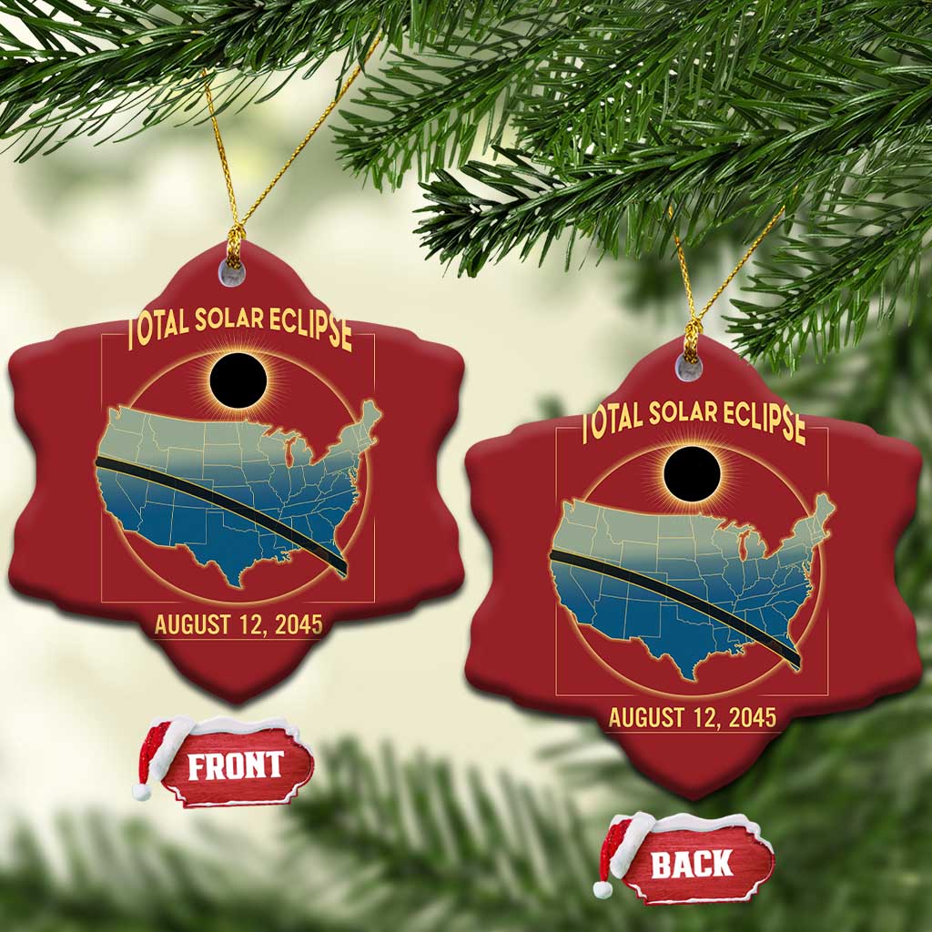 Two red heart-shaped solar eclipse map Christmas ornaments hanging on a tree